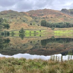 Grasmere lake reflection of hills and trees in the lake; this image selected for couples therapy