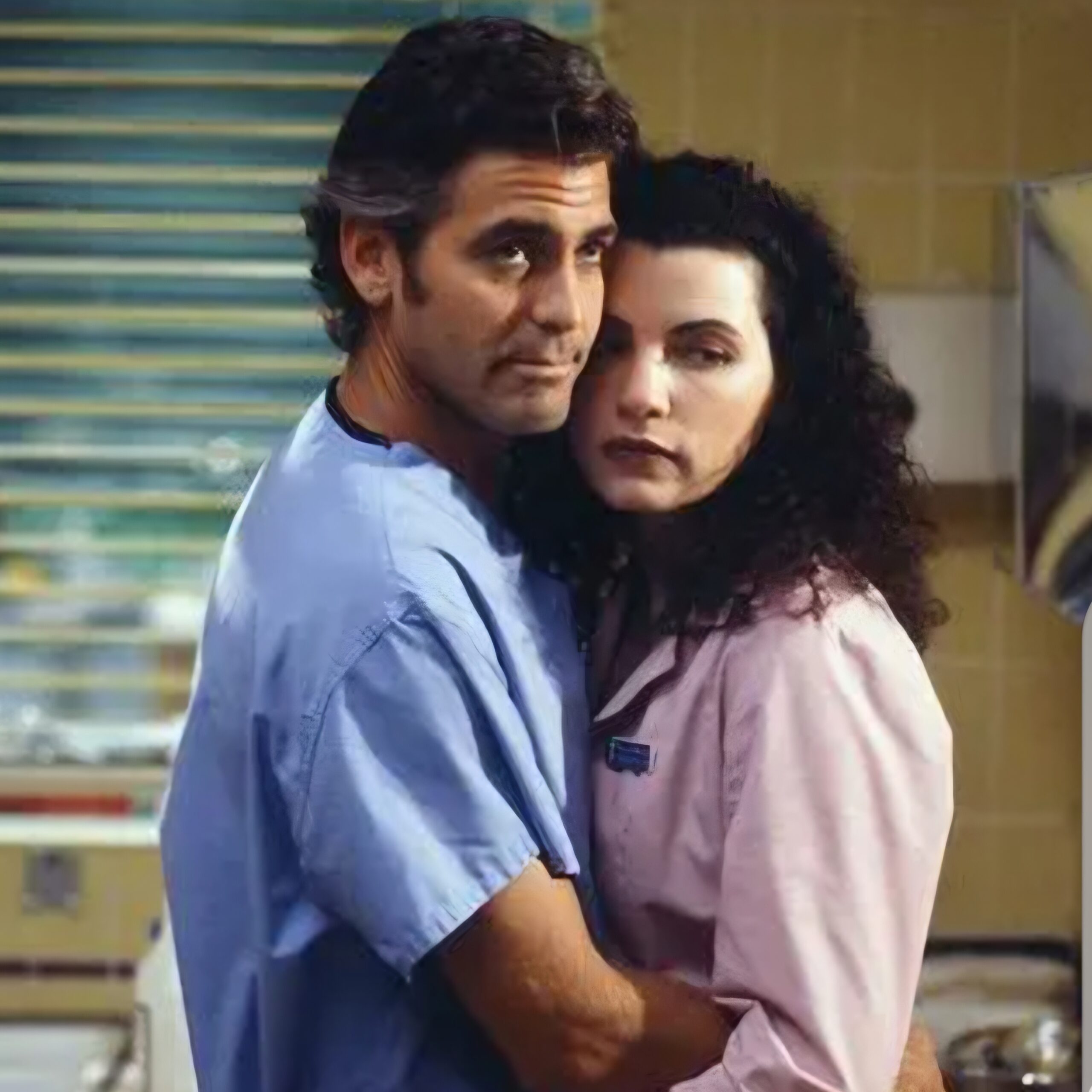 Moody photo of Ross and Carol from ER hugging, looking at the person taking the photo
